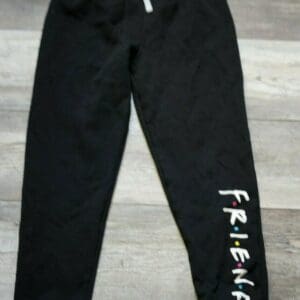 A pair of black sweatpants with the word " friends ".