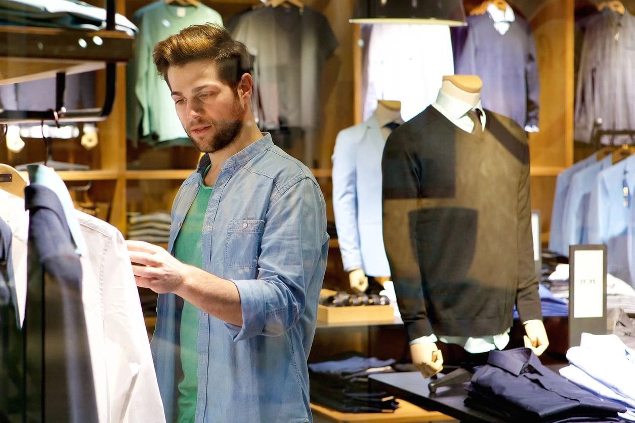 A man in a store looking at his phone.