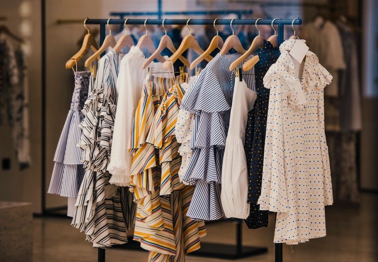 A rack of clothes hanging on the side of a wall.